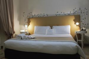 克罗托内美露住宿加早餐旅馆的一间卧室配有一张大床和两条毛巾