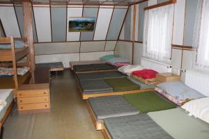 伊钦Turistická chata Prachov的带四张床的客房,位于带窗户的房间内
