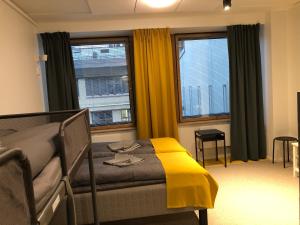 赫尔辛基Moi Aikatalo Hostel Helsinki的一间卧室配有一张黄色毯子床
