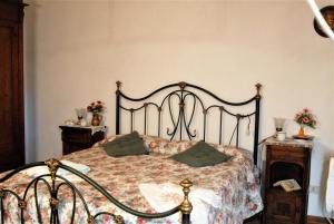 加利安奴拉卡帕内拉农家乐的一间卧室配有一张带绿色枕头的床。