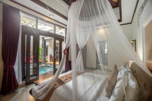 塞米亚克巴厘岛瑟敏雅克梦幻别墅酒店的一间卧室配有一张带蚊帐的床