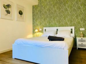 加的斯Apartamento Ecuador的卧室配有白色的床头板和白色的床