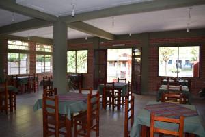 圣萨尔瓦多德朱Camino a Termas的餐厅设有木桌、椅子和窗户。