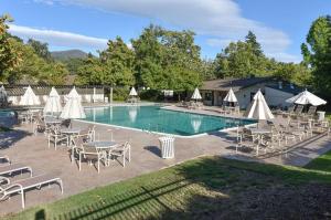 纳帕683 Cottages at Silverado residence的一个带桌椅和白色遮阳伞的游泳池