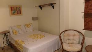 博卡奇卡Hotel Magic Tropical的一间小卧室,配有一张床和一把椅子