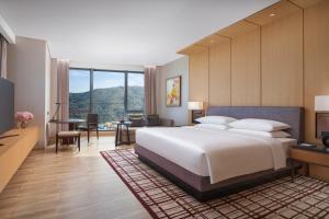 珠海横琴凯悦酒店的卧室配有一张白色大床和一张书桌