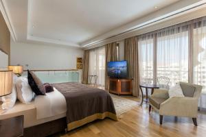 拉瑞Titanic Mardan Palace的酒店客房,配有床和电视