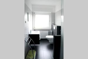 巴特瑙海姆Traumhafte Kurstadt Apartment Moderne 2ZKB Balkon PKW Stlp Self-Check-in的一间带卫生间和窗户的浴室