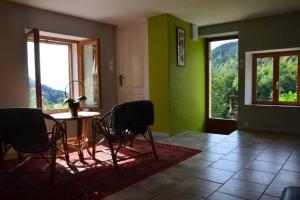 Rochessongîte de la cheneau的一间拥有绿色墙壁和桌椅的用餐室