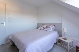 马耶讷Le Mancini - Parking et Terrasse的白色的卧室配有白色的床和一张桌子