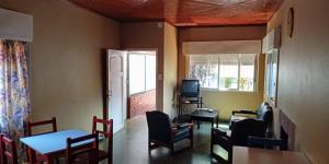 波萨达斯Lavalle hostel的一间带桌椅和电视的用餐室