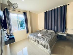 涛岛布春旅舍的一间卧室设有一张床和一个大窗户