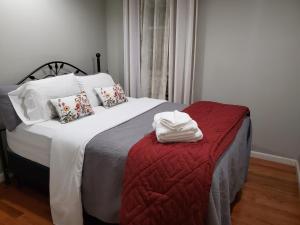 布鲁克林大西洋大道舒适公寓的一间卧室配有一张带红色毯子的大床