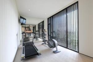 雅加达La Boheme, Rooms and Coffee的健身房设有跑步机和大窗户