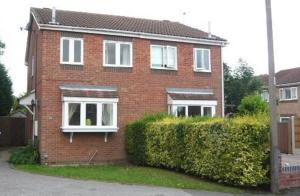 唐克斯特Doncaster - Hatfield - Large Private Garden & Parking - 2 Bedroom House - Very Quiet Cul De Sac Location的红砖房子,有白色的窗户和树 ⁇ 