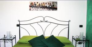 塔武利亚伊尔博尔戈旅馆的一间卧室配有一张带金属床头板的绿色床