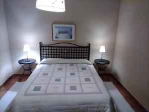 阿塞沃casa rural buenos aires的一间卧室配有一张大床和两盏灯。