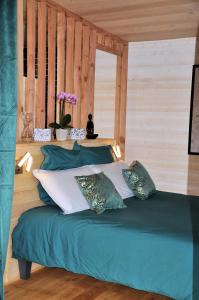 贝尔热拉克La Parenthèse的一张带绿床单和枕头的床