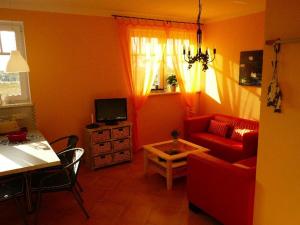 伯尔格伦德-雷特维施“斯特兰德-加特公寓”的客厅配有红色的沙发和桌子