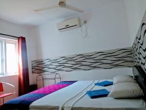 拉维尼亚山维拉图民宿的卧室配有一张壁挂波浪壁画的床。