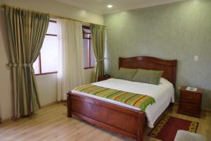 基多卡萨莫特瑞酒店的一间卧室设有一张床和两个窗户。