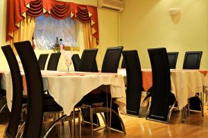 伦敦市景酒店的用餐室配有桌子和黑色椅子