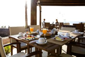达哈布达哈卜天堂酒店的一张木桌,上面放着食物和橙汁