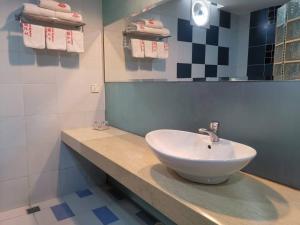 斗湖王子酒店的浴室配有盥洗盆、镜子和毛巾