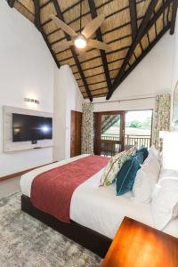 雾观Kruger Park Lodge Unit No. 608B的一间带大床和电视的卧室