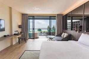 纳仲天Ana Anan Resort & Villas Pattaya的酒店客房设有床和客厅。