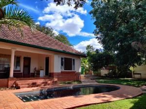 维多利亚瀑布Livingstone Lodge的庭院中带游泳池的房子
