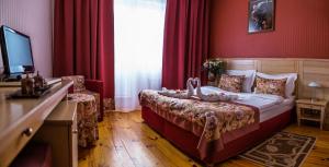 孔泽四季SPA精品酒店 的一间卧室配有一张红色墙壁的床和电视