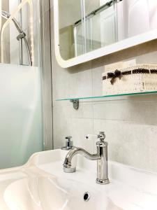 维也纳City-Maisonette的白色浴室水槽,配有镜子和水槽