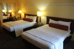 拉斯维加斯Shalimar Hotel of Las Vegas的酒店客房,设有两张床和镜子