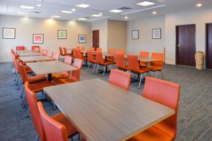 阿比林南阿比林商场快捷假日套房酒店的一间会议室,配有木桌和橙色椅子