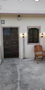 斋浦尔Jaipur Haveli的一间空房间,设有木凳和门