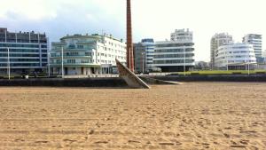 希洪Apartamento Playa Poniente的一片拥有建筑背景的沙滩