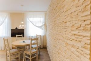 利耶帕亚Brand-New Deluxe Apartment in Liepāja的一间设有桌子和石墙的用餐室
