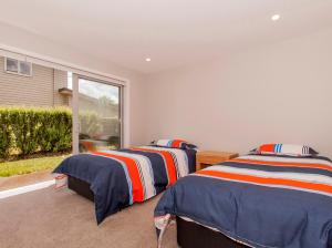 Tattletails Rest - Whitianga Holiday House客房内的一张或多张床位