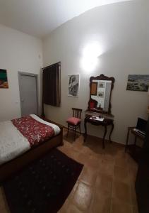阿塞米尼Villa Iole的一间卧室配有一张床和一张带镜子的桌子