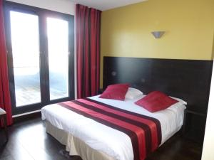 Belleville-sur-LoireLogis Hôtel Terre de Loire的一间卧室配有一张大床和红色枕头