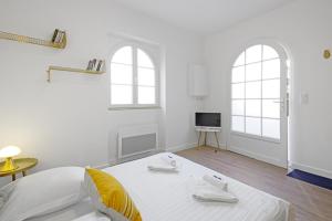 比亚里茨Nice 3 stars flat w beautiful terrace - Biarritz - Welkeys的白色的客房设有一张床和两个窗户。