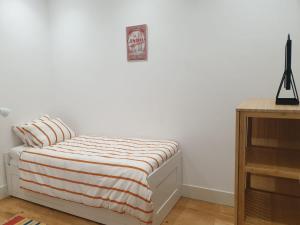 里斯本里斯本居家公寓的一间卧室配有带条纹毯子的床