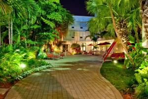 迈阿密海滩多切斯特套房酒店的棕榈树花园的走道和建筑