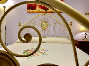 多尔加利A Casa di Nonno Dorgali的一张带白色床单的床,上面有鲜花