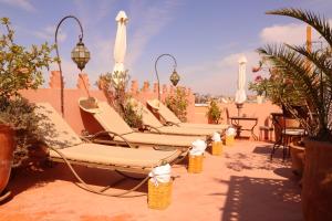 马拉喀什安达马里酒店的庭院里摆放着一排躺椅