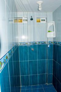 普罗维登西亚Posada Sweet Anashly的蓝色瓷砖浴室设有蓝色瓷砖淋浴