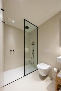 波尔图BessaApartments的一间带玻璃淋浴和卫生间的浴室