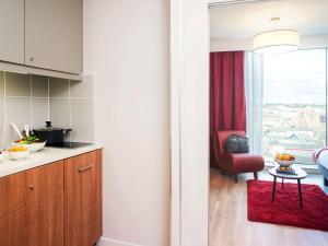 伯明翰伯明翰市中心阿德吉奥公寓式酒店的厨房配有红色椅子和红色地毯