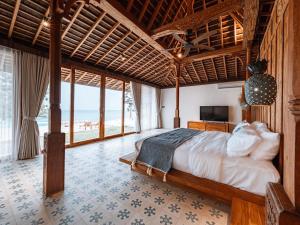 珀尼达岛Villa Victoria Nusa Penida的一间卧室设有一张床,享有海景